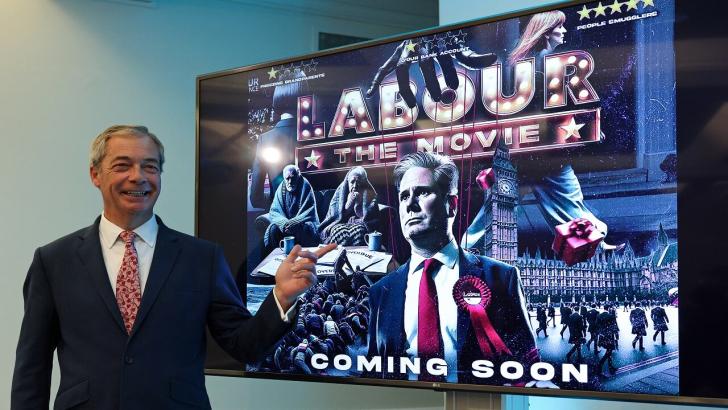 Nigel Farage points at poster of Keir Starmer